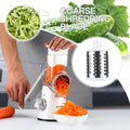 Rotary Cheese Grater with 3 Interchangeable Blades and Non-Slip Suction Base - Manual Vegetable Slicer and Nut Grinder with Included Brush Peeler - White